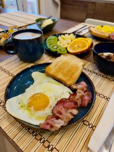 a breakfast plate with eggs bacon and toast and coffee at Casaldo's rooms in Florence