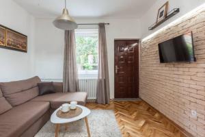 a living room with a couch and a brick wall at Belgrade Central Station 3 in Belgrade