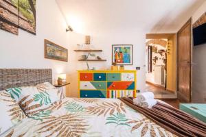 - une chambre avec un lit et une commode colorée dans l'établissement La Casina di Viola, à Livourne