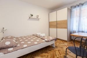 a bedroom with a bed and a table and chairs at Belgrade Central Station 3 in Belgrade