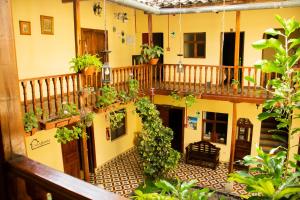 um edifício de apartamentos com uma varanda com plantas em Casa Bonita Colonial em Cajamarca