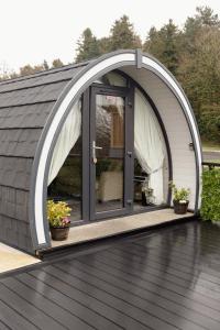 an arched door on a house with a patio at Coolaness Glamping in Irvinestown