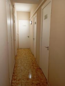 a hallway with two doors and a tile floor at La Cabana in Organyà