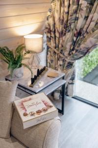 a table with a box of donuts on a couch at Coolaness Glamping in Irvinestown