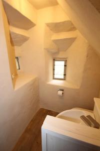 a bathroom with a white toilet and a window at allio - das turmchalet in Berching