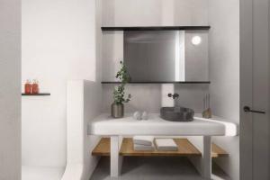 a white bathroom with a sink and a mirror at Seascape, Apartment with sea view 3 in Áno Meriá