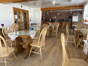 a dining room with wooden chairs and a table at Columbine Inn and Suites in Leadville +9 photos