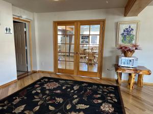 a living room with a table and a rug at Columbine Inn and Suites in Leadville +11 photos