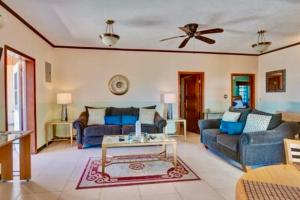 a living room with two blue couches and a table at 4C's Vacation Suites in Lower South Hill