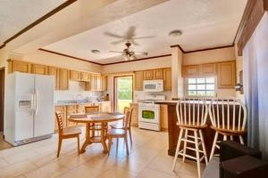 a kitchen with a table and chairs and a white refrigerator at 4C's Vacation Suites in Lower South Hill