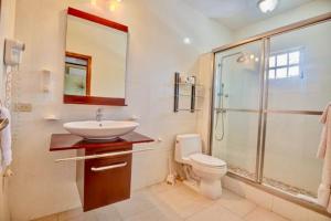 a bathroom with a toilet and a sink and a shower at 4C's Vacation Suites in Lower South Hill