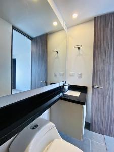 a bathroom with a white toilet and a sink at Apto pent-house amoblado para estrenar in Bogotá