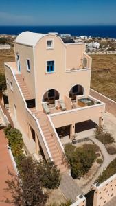 an aerial view of a house with the ocean in the background at San Constantino Boutique Villa in Fira