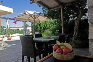 a table with a basket of fruit and an umbrella at Casa il Terrazzino in Anacapri