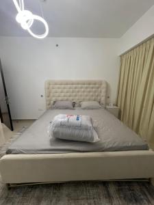 a bed in a bedroom with a large mattress at The blue residence in Abu Dhabi