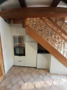 a kitchen with a staircase in a house at A l'OREE DU BOIS in Ville-Houdlémont +5 photos