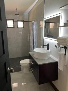 a bathroom with a sink and a toilet at Chabayali House in San Juan del Sur