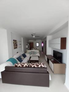 a living room with a large bed and a couch at Disfrutar de la playa in Playa de Gandia