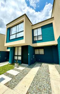 a house with a blue and white at Casa Turística en el Quindío in La Tebaida +28 photos