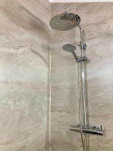 a shower with a shower head in a bathroom at Casa da Nazaré in Portinho da Arrábida +37 photos