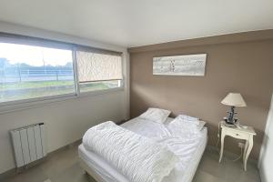 En eller flere senge i et værelse på Family nest located in Hermanville-sur-mer
