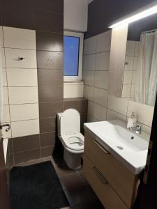 a bathroom with a white toilet and a sink at Athens Gate Acropolis One bedroom apartment in Athens