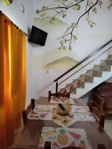 a dining room with a table and a staircase at Departamentos Anahí in Río Colorado