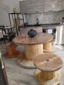 a wooden table in a kitchen with wooden stools at La Casa dei Ricordi in Campagnano di Roma