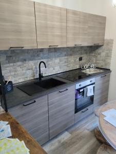 a kitchen with a sink and a stove at La Casa dei Ricordi in Campagnano di Roma