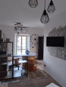 a dining room with a table and a tv at La Casa dei Ricordi in Campagnano di Roma