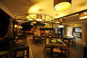 - un restaurant avec des tables et des chaises dans une salle dans l'établissement Gloria Hotel, à Kigali