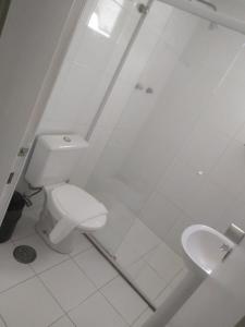 a white bathroom with a toilet and a sink at M-Flat Hotel Platinum - Paulista in Sao Paulo