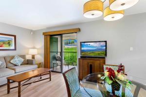 a living room with a couch and a table at Gardens at West Maui in Lahaina