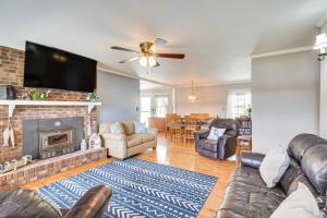 a living room with leather furniture and a fireplace at Waterfront Lake Gaston Home with Private Dock! in Littleton
