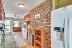 a kitchen with a brick wall and a refrigerator at Waterfront Lake Gaston Home with Private Dock! in Littleton