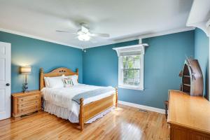 a blue bedroom with a bed and a ceiling fan at Waterfront Lake Gaston Home with Private Dock! in Littleton