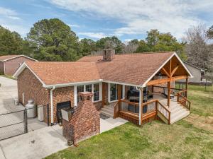 a house with a porch and a deck at Waterfront Lake Gaston Home with Private Dock! in Littleton