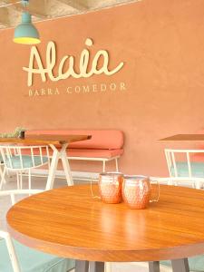 a wooden table with two cups on top of it at Trip Monkey del Río in San Gil