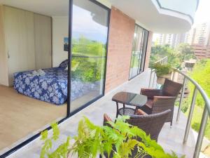 a balcony with a bed and a table and chairs at Paradise in Envigado- in Envigado