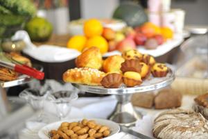 a table with plates of pastries and other foods at Gloria Hotel in Kigali