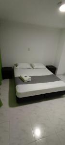 a bed in a room with a white floor at HOTEL PROVENZA MEDELLIN in Medellín