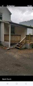 a house with a porch and a wooden fence at LOVELY RENOVATED 2 BEDROOM HOME WITH FREE Parking in Albany