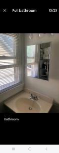 a bathroom with a sink and a mirror at LOVELY RENOVATED 2 BEDROOM HOME WITH FREE Parking in Albany