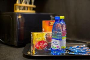 a tray with two bottles of water and a box at Luksus Apartamenty - Mariacka in Szczecin