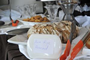 a table with a loaf of bread and a plate of food at Gloria Hotel in Kigali