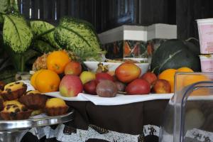 a bunch of fruits on plates on a table at Gloria Hotel in Kigali