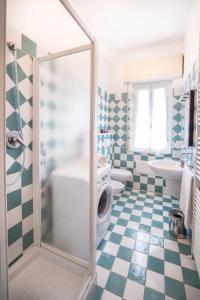 a bathroom with a shower with a washing machine in it at Appartamenti Bemar in Diano Marina