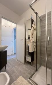 a bathroom with a glass shower and a sink at La Rondine in Gravedona +24 photos
