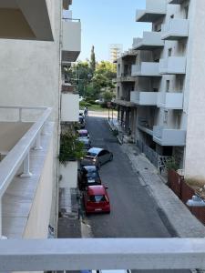 a street with cars parked on the side of a building at Athens Gate Acropolis One bedroom apartment in Athens