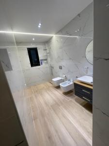a bathroom with two sinks and two toilets at Luxury Rooftop Vlora in Vlorë